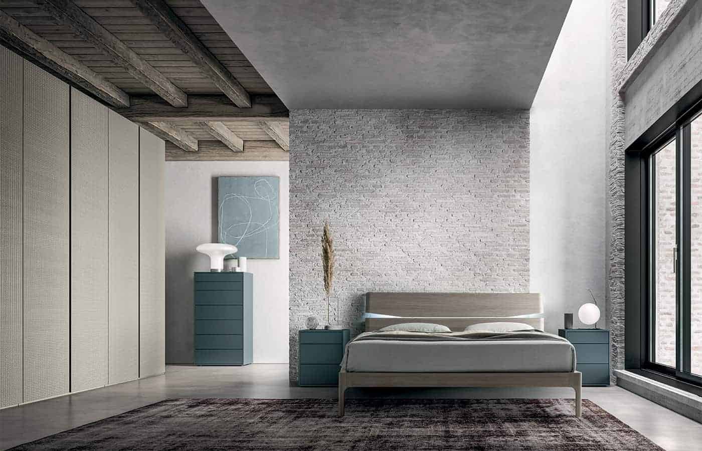 Il letto matrimoniale della collezione Panama visto all'interno di una camera da letto arredata